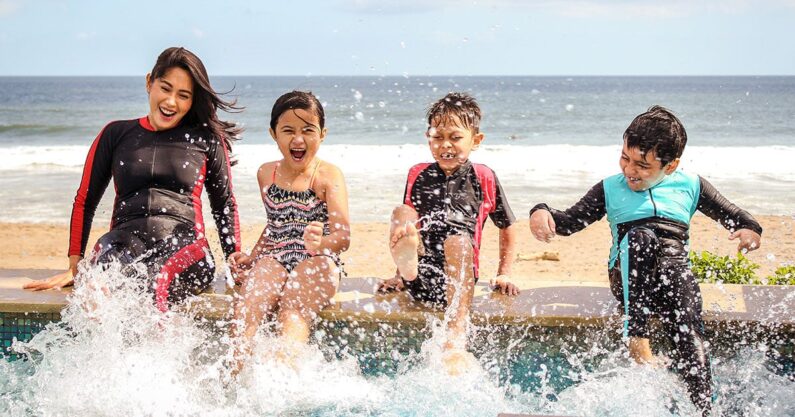 Happy kids at a beach-side pool