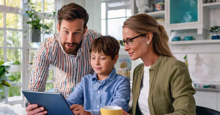 Mother and father with son viewing tablet