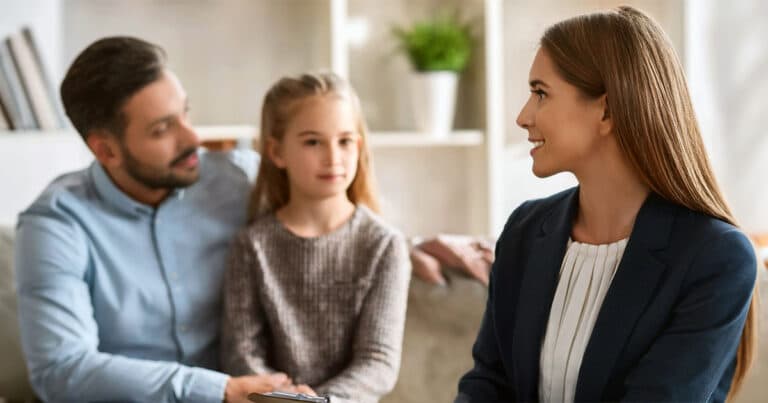 Professional woman interviewing father and daughter