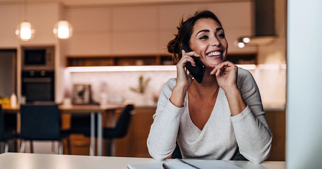 Woman on phone and computer at the same time